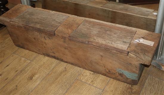 An Indonesian dug-out teak storage container with two sliding lids W.111cm